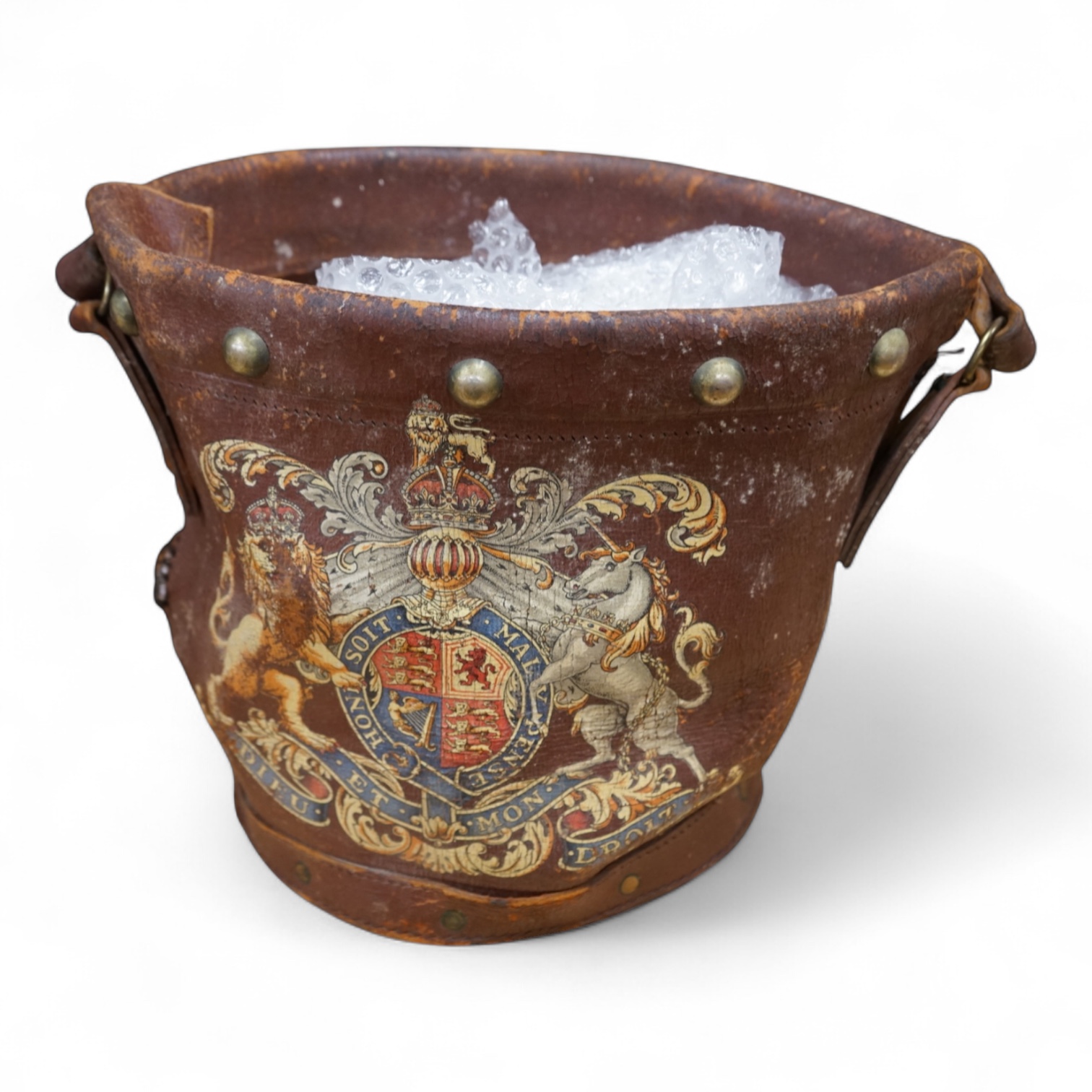 A brown leather fire bucket with Royal Coat of Arms decoration, 25cm high